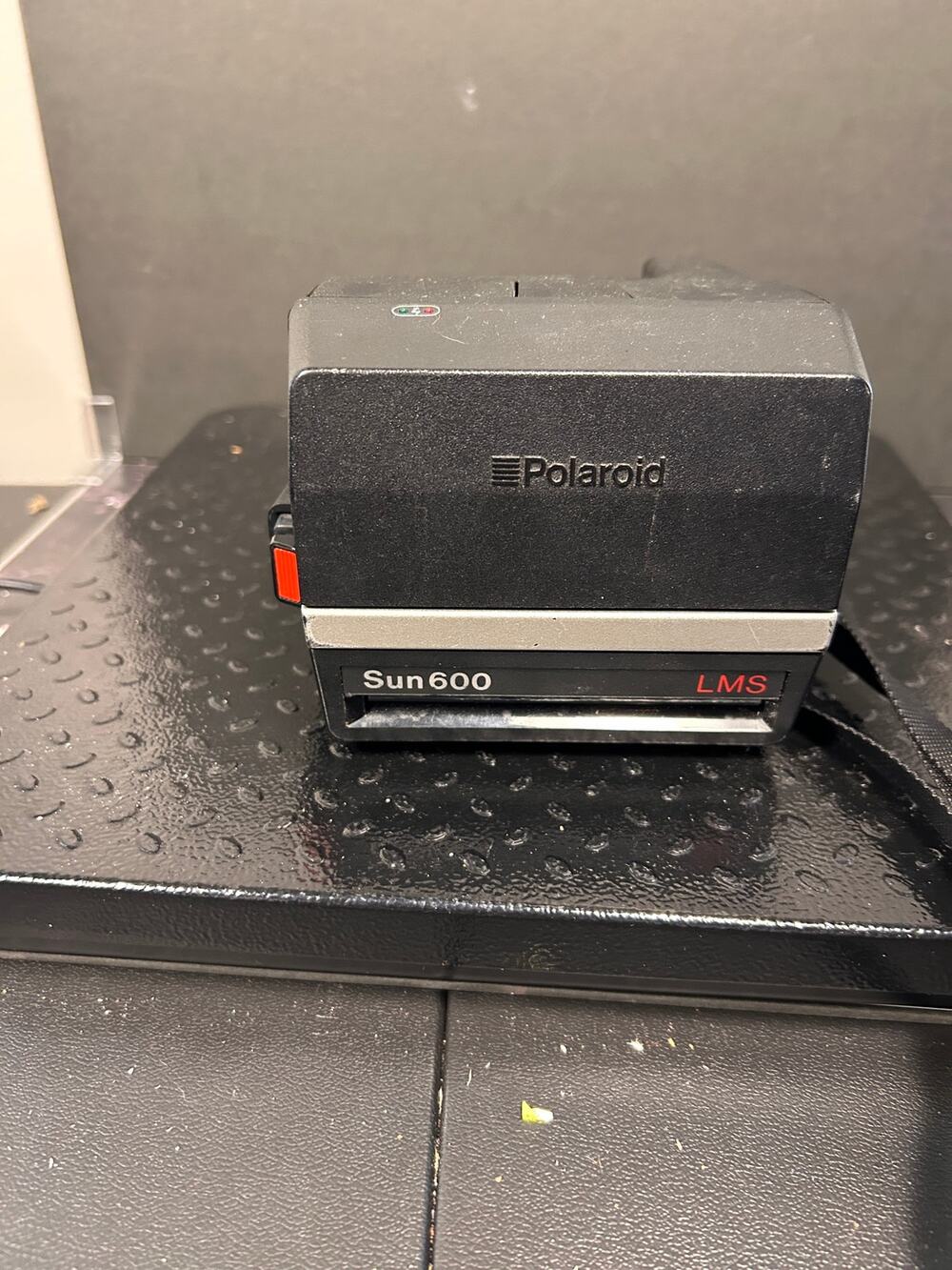 vintage Polaroid Sun 600 LMS instant film camera with red "LMS" branding